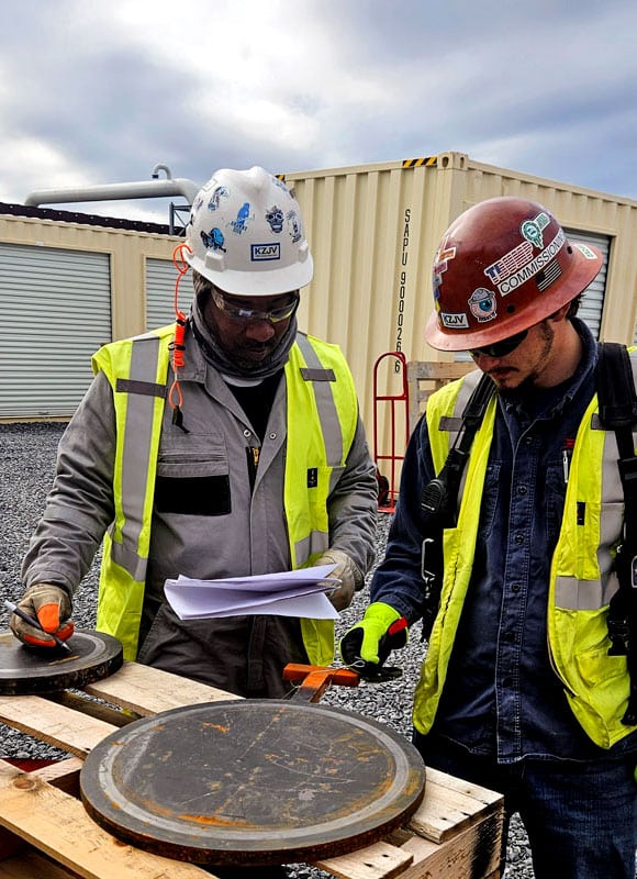 Two technicians matching RF tag data to GPS location
